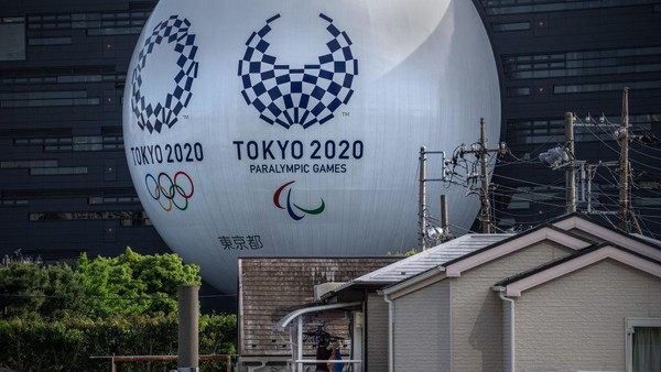 TOKYO, JAPAN - MAY 06: A huge semi-sphere with the logos of the Tokyo Olympics and Paralympics, displayed on the side of a driving school building, looms over neighbouring houses on May 6, 2021 in Tokyo, Japan. Tokyos governor, Yuriko Koike, is expected to request that the citys current state of emergency be extended to May 31 as the city and other parts of the country experience a surge in COVID-19 cases. With just under three months remaining until the Olympic Games, concern continues to mount over the feasibility of hosting the event amid the ongoing pandemic. (Photo by Carl Court/Getty Images)