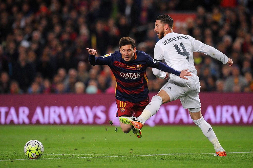 BARCELONA, SPAIN - APRIL 02:  Sergio Ramos of Real Madrid CF battles for the ball with Lionel Messi of FC Barcelona during the La Liga match between FC Barcelona and Real Madrid CF at Camp Nou on April 2, 2016 in Barcelona, Spain.  (Photo by Alex Caparros/Getty Images)
