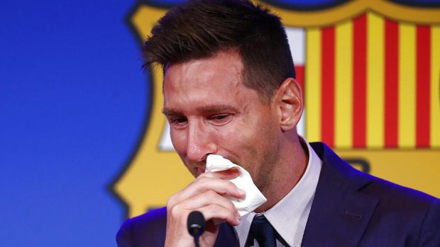 The statue of Barcelona's former player and coach Johan Cruyff, in front of a mural of Lionel Messi outside the Camp Nou stadium in Barcelona, Spain, Thursday, Aug. 5, 2021. Barcelona announced Thursday that Messi will not stay with the club, saying that the Spanish league's financial regulations made it impossible to sign the Argentina star to a new contract. (AP Photo/Joan Monfort)