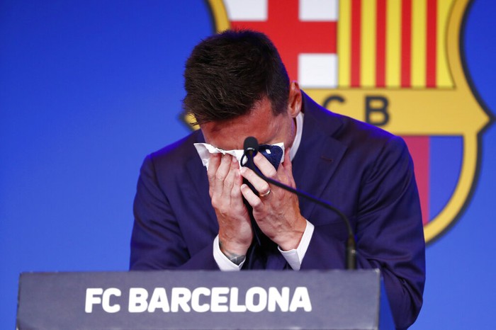 The statue of Barcelonas former player and coach Johan Cruyff, in front of a mural of Lionel Messi outside the Camp Nou stadium in Barcelona, Spain, Thursday, Aug. 5, 2021. Barcelona announced Thursday that Messi will not stay with the club, saying that the Spanish leagues financial regulations made it impossible to sign the Argentina star to a new contract. (AP Photo/Joan Monfort)