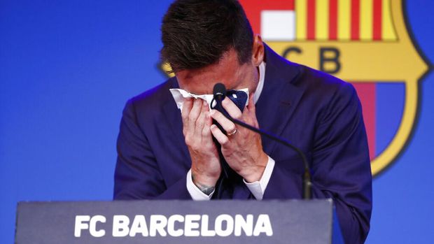 The statue of Barcelona's former player and coach Johan Cruyff, in front of a mural of Lionel Messi outside the Camp Nou stadium in Barcelona, Spain, Thursday, Aug. 5, 2021. Barcelona announced Thursday that Messi will not stay with the club, saying that the Spanish league's financial regulations made it impossible to sign the Argentina star to a new contract. (AP Photo/Joan Monfort)