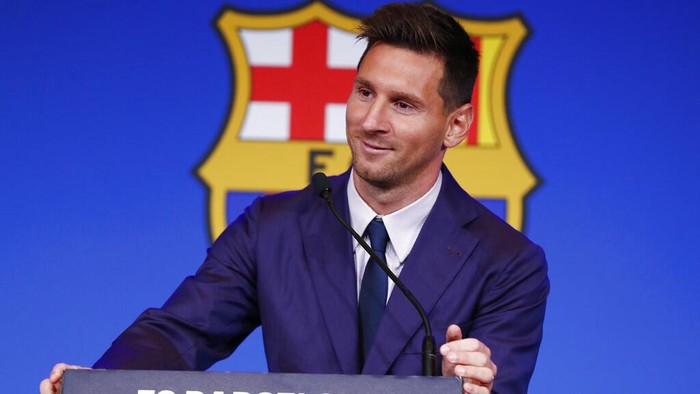 The statue of Barcelonas former player and coach Johan Cruyff, in front of a mural of Lionel Messi outside the Camp Nou stadium in Barcelona, Spain, Thursday, Aug. 5, 2021. Barcelona announced Thursday that Messi will not stay with the club, saying that the Spanish leagues financial regulations made it impossible to sign the Argentina star to a new contract. (AP Photo/Joan Monfort)
