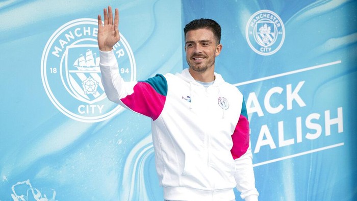 Manchester Citys new signing Jack Grealish waves as he is unveiled to supporters the Etihad Stadium in Manchester, England, Monday Aug. 9, 2021. (AP Photo/Jon Super)