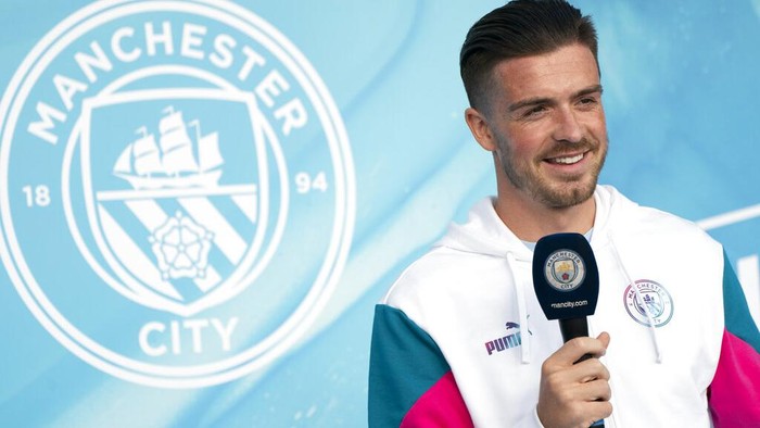 Manchester Citys new signing Jack Grealish takes to the stage as he is unveiled to supporters the Etihad Stadium in Manchester, England, Monday Aug. 9, 2021. (AP Photo/Jon Super)
