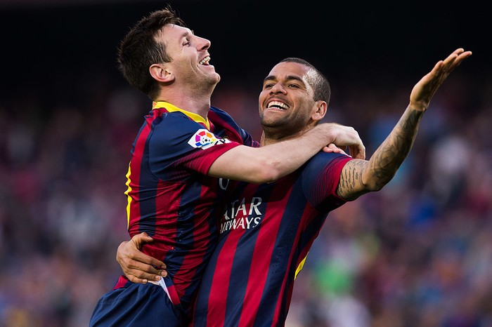 BARCELONA, SPAIN - MARCH 16: Lionel Messi of FC Barcelona celebrates with his team mate Daniel Alves after scoring his teams sixth goal during the La Liga match between FC Barcelona and CA Osasuna at Camp Nou on March 16, 2014 in Barcelona, Spain. (Photo by Alex Caparros/Getty Images)
