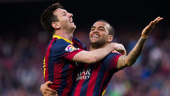 BARCELONA, SPAIN - MARCH 16: Lionel Messi of FC Barcelona celebrates with his team mate Daniel Alves after scoring his teams sixth goal during the La Liga match between FC Barcelona and CA Osasuna at Camp Nou on March 16, 2014 in Barcelona, Spain. (Photo by Alex Caparros/Getty Images)