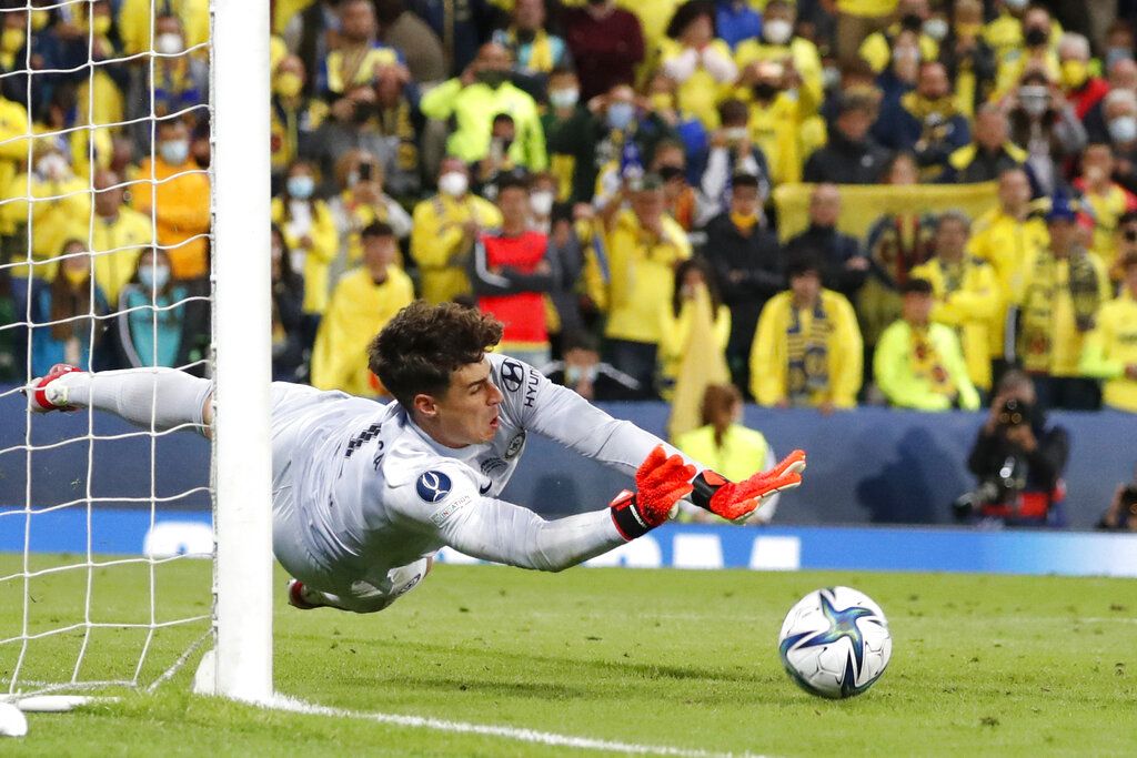 Chelsea's goalkeeper Kepa Arrizabalaga saves the final shot during the penalty shootout of the UEFA Super Cup soccer match between Chelsea and Villarreal at Windsor Park in Belfast, Northern Ireland, Wednesday, Aug. 11, 2021. (AP Photo/Peter Morrison)