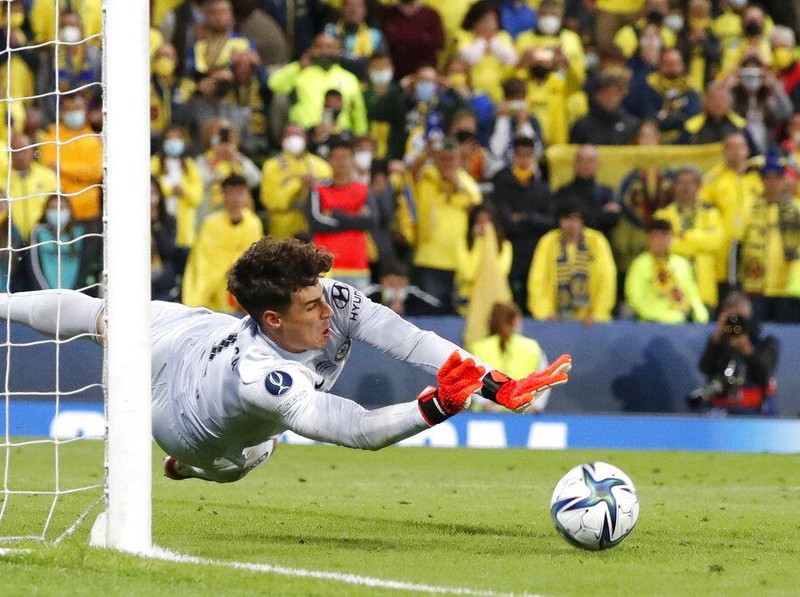 Chelsea's goalkeeper Kepa Arrizabalaga saves the final shot during the penalty shootout of the UEFA Super Cup soccer match between Chelsea and Villarreal at Windsor Park in Belfast, Northern Ireland, Wednesday, Aug. 11, 2021. (AP Photo/Peter Morrison)