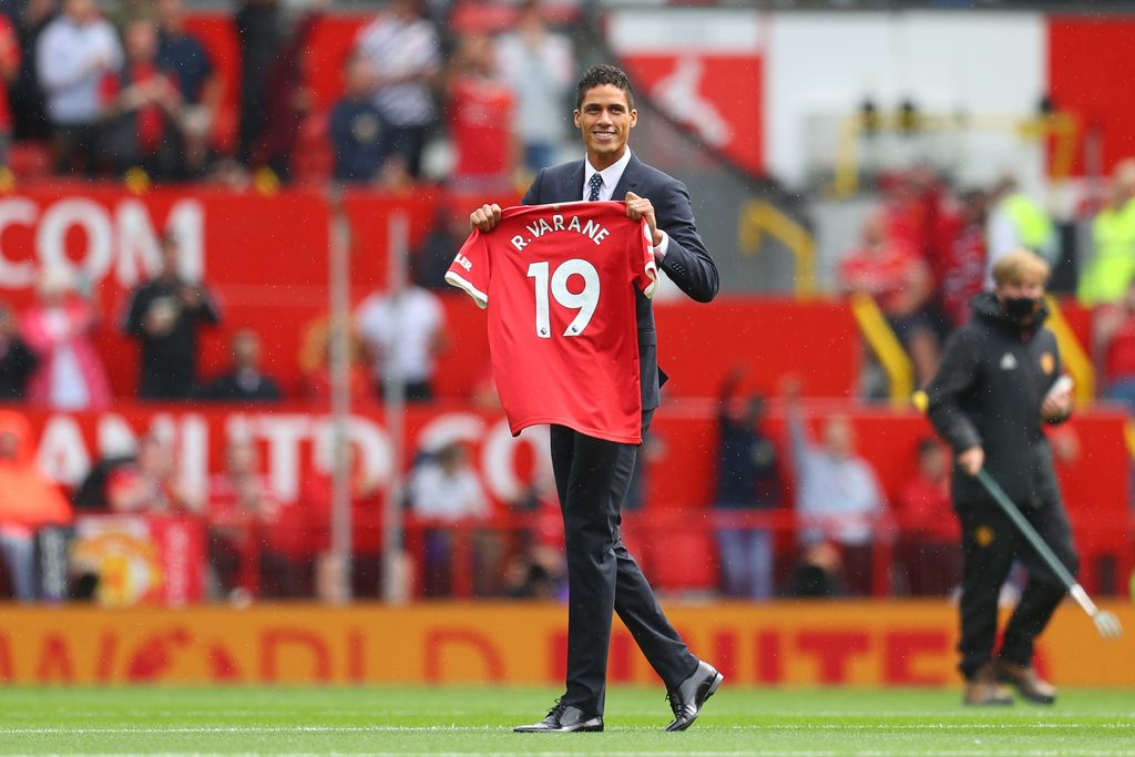 MANCHESTER, ENGLAND - AUGUST 14: New signing, Raphael Varane of Manchester United is introduced to fans on the pitch prior to the Premier League match between Manchester United  and  Leeds United at Old Trafford on August 14, 2021 in Manchester, England. (Photo by Catherine Ivill/Getty Images,)