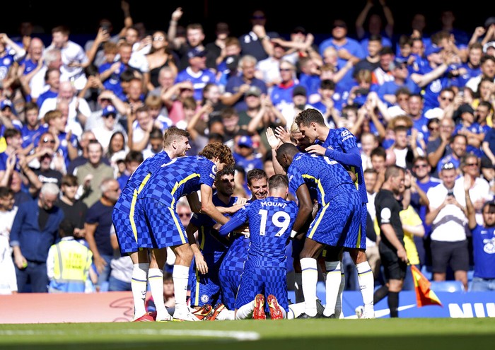 Chelsea players celebrate after teammate Trevoh Chalobah scored their sides third goal of the game during the English Premier League soccer match between Chelsea and Crystal Palace at Stamford Bridge, London, Saturday, Aug. 14, 2021. (Tess Derry/PA via AP)