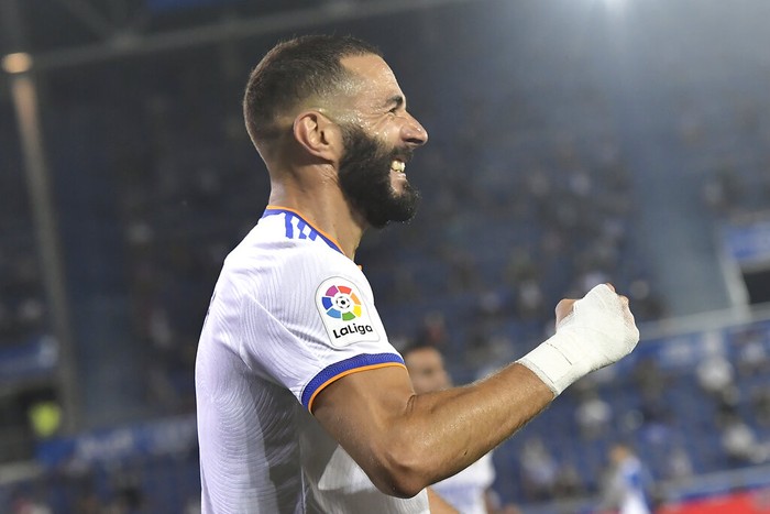 Real Madrid's Karim Benzema celebrates after scoring his side's third goal during a Spanish La Liga soccer match between Alaves and Real Madrid at the Mendizorroza stadium in Vitoria, Spain, Saturday, Aug. 14, 2021. (AP Photo/Alvaro Barrientos)