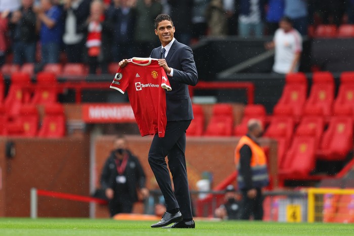 MANCHESTER, ENGLAND - AUGUST 14: New signing, Raphael Varane of Manchester United is introduced to fans on the pitch prior to the Premier League match between Manchester United  and  Leeds United at Old Trafford on August 14, 2021 in Manchester, England. (Photo by Catherine Ivill/Getty Images,)