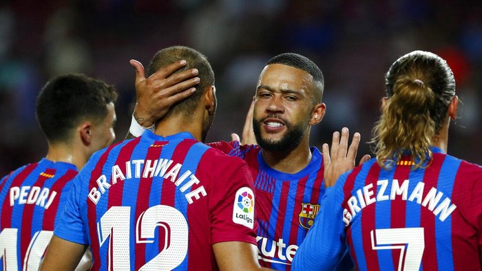 Barcelonas Martin Braithwaite, 2nd left, celebrates with teammate Memphis Depay, 2nd right,after scoring his sides third goal during a Spanish La Liga soccer match between Barcelona and Real Sociedad at Camp Nou stadium in Barcelona, Spain, Sunday, Aug. 15, 2021. (AP Photo/Joan Monfort)