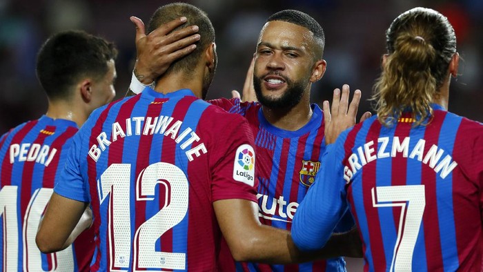 Barcelonas Martin Braithwaite, 2nd left, celebrates with teammate Memphis Depay, 2nd right,after scoring his sides third goal during a Spanish La Liga soccer match between Barcelona and Real Sociedad at Camp Nou stadium in Barcelona, Spain, Sunday, Aug. 15, 2021. (AP Photo/Joan Monfort)