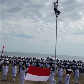 Joni memanjat tiang bendera untuk memperbaiki pengait yang bermasalah saat upacara HUT ke-73 RI. (Screenshot video viral)