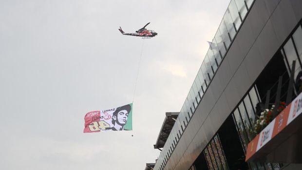 MotoGP - Austrian Grand Prix - Red Bull Ring, Spielberg, Austria - August 15, 2021 A helicopter flies a flag depicting Petronas Yamaha SRT's Valentino Rossi REUTERS/Borut Zivulovic