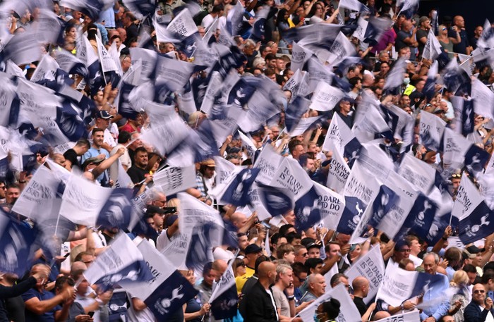 LONDON, ENGLAND - AUGUST 15:  Tottenham Hotspur fans wave flags prior to the Premier League match between Tottenham Hotspur and Manchester City at Tottenham Hotspur Stadium on August 15, 2021 in London, England. (Photo by Shaun Botterill/Getty Images)