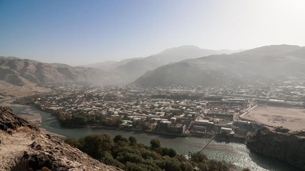 Faizabad is the north-eastern most city in Afghanistan, in the province of Badakhshan. It is built around a curve in the river, and is divided into the old city, on the Northern bank and the new city, more visible in this photo. A buzkashi field can be seen in the lower right.