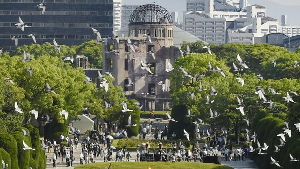 Hiroshima Peace Memorial Birds fly over the Peace Memorial Park with a view of the gutted Atomic Bomb Dome at a ceremony commemorating the 76th anniversary of the world's first atomic bombing on the city of Hiroshima, Japan, August 6, 2021. Mandatory credit Kyodo/via REUTERS ATTENTION EDITORS - THIS IMAGE WAS PROVIDED BY A THIRD PARTY. MANDATORY CREDIT. JAPAN OUT. NO COMMERCIAL OR EDITORIAL SALES IN JAPAN. THIS IMAGE WAS PROCESSED BY REUTERS TO ENHANCE QUALITY, AN UNPROCESSED VERSION HAS BEEN PROVIDED SEPARATELY.