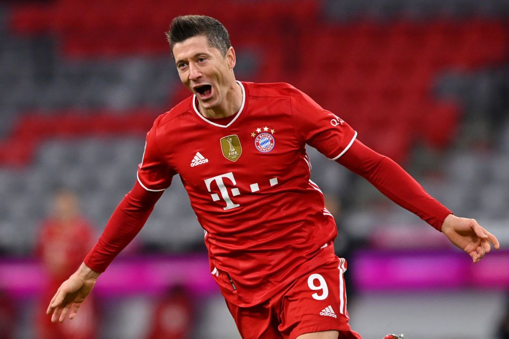 MUNICH, GERMANY - MARCH 06: Robert Lewandowski of FC Bayern Muenchen celebrates after scoring their team's fourth goal, completing his hat-trick during the Bundesliga match between FC Bayern Muenchen and Borussia Dortmund at Allianz Arena on March 06, 2021 in Munich, Germany. Sporting stadiums around Germany remain under strict restrictions due to the Coronavirus Pandemic as Government social distancing laws prohibit fans inside venues resulting in games being played behind closed doors. (Photo by Sebastian Widmann/Getty Images)