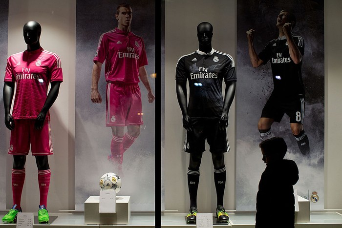 MADRID, SPAIN - DECEMBER 09:  A child walks infront of  the Real Madrid Officia Store window before the UEFA Champions League Group B match between Real Madrid CF and PFC Ludogorets Razgrad at Estadio Santiago Bernabeu outdoors on December 9, 2014 in Madrid, Spain.  (Photo by Gonzalo Arroyo Moreno/Getty Images)