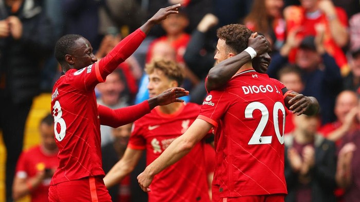 LIVERPOOL, ENGLAND - AUGUST 21: Diogo Jota of Liverpool celebrates with Naby Keita and team mates after scoring their sides first goal during the Premier League match between Liverpool and Burnley at Anfield on August 21, 2021 in Liverpool, England. (Photo by Catherine Ivill/Getty Images)
