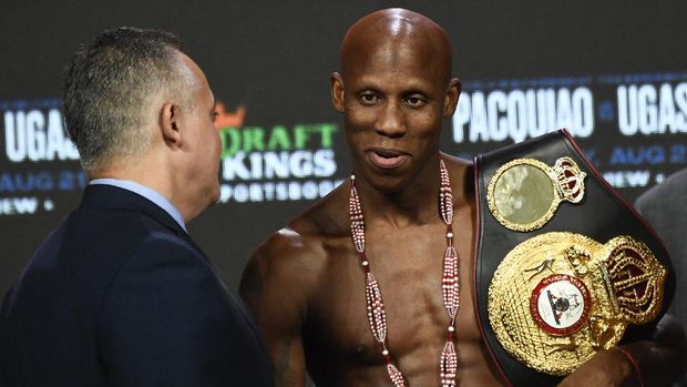 WBA welterweight champion Yordenis Ugas of Cuba holds his belt before his fight against Senator Manny Pacquiao of the Philippines (not pictured) during the weigh-in on August 20, 2021 at MGM Grand Garden Arena in Las Vegas, Nevada. - Pacquiao and Ugas will fight Saturday August 21 at T-Mobile Arena. (Photo by Patrick T. FALLON / AFP)