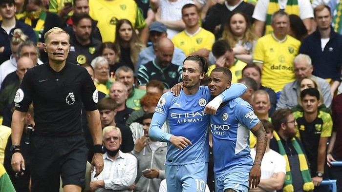 Manchester Citys Jack Grealish with teammate Gabriel Jesus celebrates after scoring his sides second goal during the English Premier League soccer match between Manchester City and Norwich City at Etihad stadium in Manchester, England, Saturday, Aug. 21, 2021. (AP Photo/Rui Vieira)