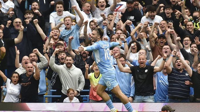 Manchester Citys Jack Grealish celebrates after scoring his sides second goal during the English Premier League soccer match between Manchester City and Norwich City at Etihad stadium in Manchester, England, Saturday, Aug. 21, 2021. (AP Photo/Rui Vieira)