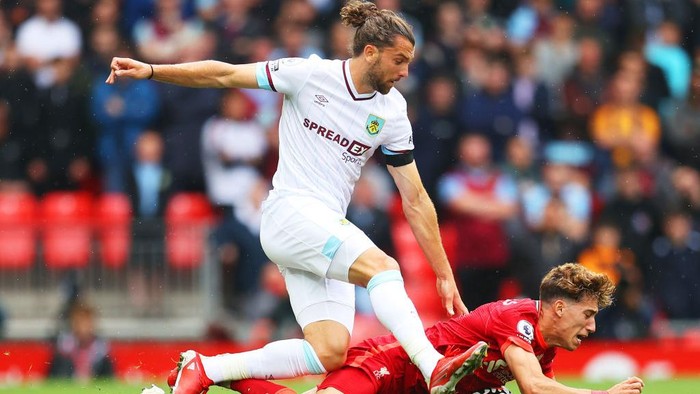 LIVERPOOL, ENGLAND - AUGUST 21: Kostas Tsimikas of Liverpool is challenged by Jay Rodriguez of Burnley during the Premier League match between Liverpool and Burnley at Anfield on August 21, 2021 in Liverpool, England. (Photo by Catherine Ivill/Getty Images)