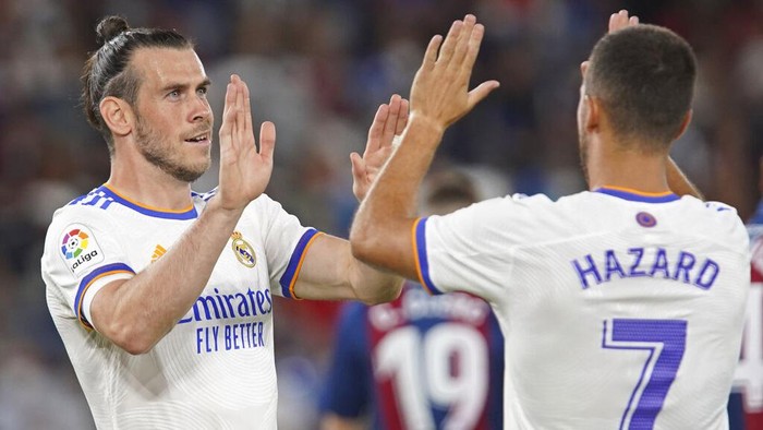 Real Madrids Gareth Bale, left, celebrates with Eden Hazard after scoring his sides opening goal during a Spanish La Liga soccer match between Levante and Real Madrid at the Ciutat de Valencia stadium in Valencia, Spain, Sunday, Aug. 22, 2021. (AP Photo/Alberto Saiz)