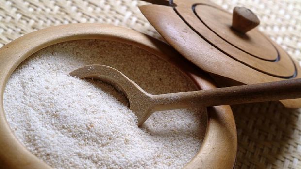 Farinha de Mandioca, toasted cassava flour in a wooden bow, it is a very popular Brazilian side dish using toasted farinha de mandioca