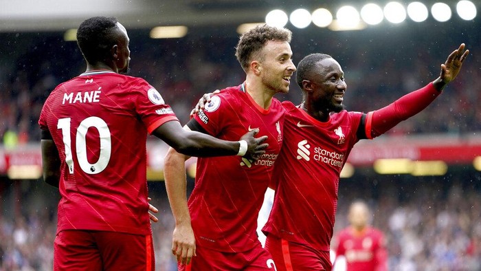Liverpools Diogo Jota, center, celebrates scoring with teammates during the English Premier League soccer match between Liverpool and Burnley at Anfield, Liverpool, England, Saturday Aug. 21, 2021. (Mike Egerton/PA via AP)
