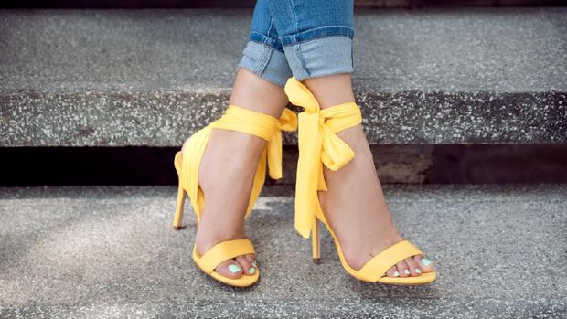 Woman wearing yellow heels sandals outdoors
