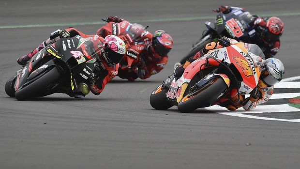 Spain's rider Pol Espargaro of the Repsol Honda Team steers his motorcycle followed by Spain's rider Aleix Espargaro of the Aprilia Racing Team Gresini during the MotoGP race at the British Motorcycle Grand Prix at the Silverstone racetrack, in Silverstone, England, Sunday, Aug. 29, 2021. (AP Photo/Rui Vieira)