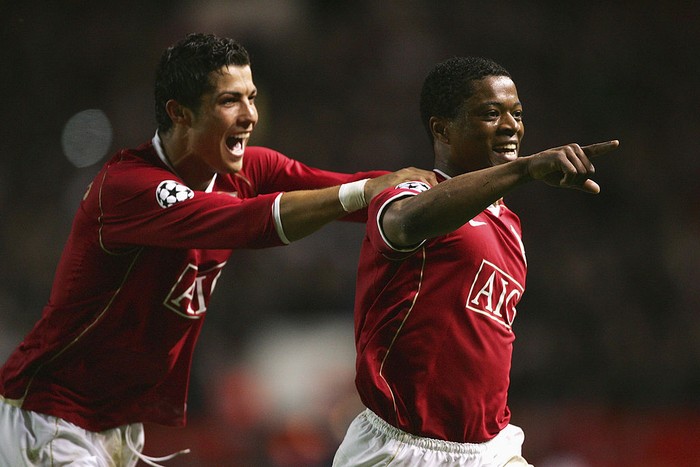 MANCHESTER, UNITED KINGDOM - APRIL 10:  Patrice Evra of Manchester United celebrates scoring his teams seventh goal with team mate Cristiano Ronaldo during the UEFA Champions League Quarter Final, second leg match between Manchester United and AS Roma at Old Trafford on April 10, 2007 in Manchester, England.  (Photo by Alex Livesey/Getty Images)
