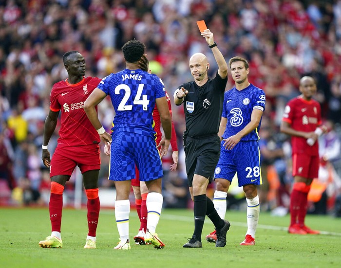 Chelseas Reece James is shown a red card by referee Anthony Taylor during the English Premier League soccer match between Liverpool and Chelsea at Anfield, Liverpool, England, Saturday, Aug. 28, 2021. (Mike Egerton/PA via AP)