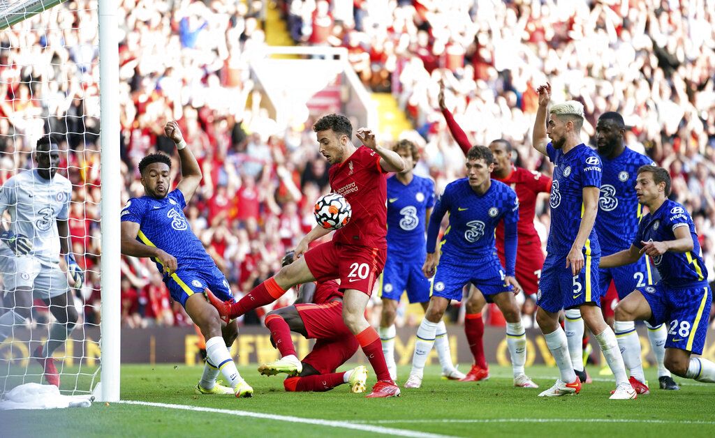 Chelsea's Reece James is shown a red card by referee Anthony Taylor during the English Premier League soccer match between Liverpool and Chelsea at Anfield, Liverpool, England, Saturday, Aug. 28, 2021. (Mike Egerton/PA via AP)
