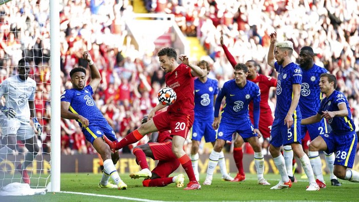 Chelseas Reece James is shown a red card by referee Anthony Taylor during the English Premier League soccer match between Liverpool and Chelsea at Anfield, Liverpool, England, Saturday, Aug. 28, 2021. (Mike Egerton/PA via AP)