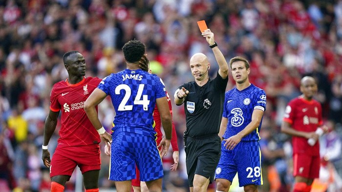 Chelseas Reece James is shown a red card by referee Anthony Taylor during the English Premier League soccer match between Liverpool and Chelsea at Anfield, Liverpool, England, Saturday, Aug. 28, 2021. (Mike Egerton/PA via AP)