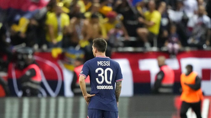 Aksi Lionel Messi Saat Debut Bareng PSG Reims' Marshall Munetsi, left, challenges for the ball with PSG's Lionel Messi during the France League One soccer match between Reims and Paris Saint-Germain, at the Stade Auguste-Delaune in Reims, France, Sunday, Aug. 29, 2021. (AP Photo/Francois Mori)