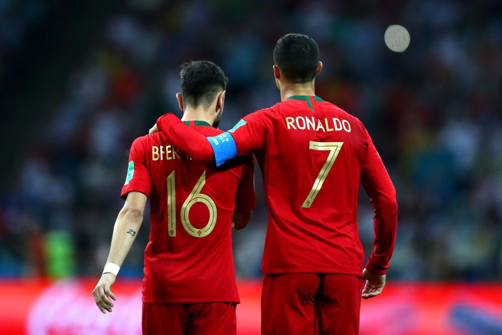 SOCHI, RUSSIA - JUNE 15:  Cristiano Ronaldo of Portugal embraces team mate Bruno Fernandes  during the 2018 FIFA World Cup Russia group B match between Portugal and Spain at Fisht Stadium on June 15, 2018 in Sochi, Russia.  (Photo by Dean Mouhtaropoulos/Getty Images)