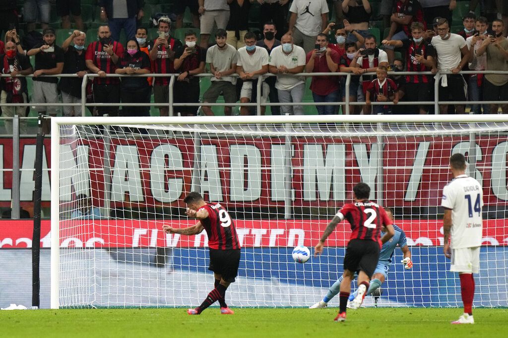 AC Milan's Olivier Giroud celebrates after scoring his side's third goal during a Serie A soccer match between AC Milan and Cagliari, at the San Siro stadium in Milan, Italy, Monday, Aug. 30, 2021. (AP Photo/Luca Bruno)