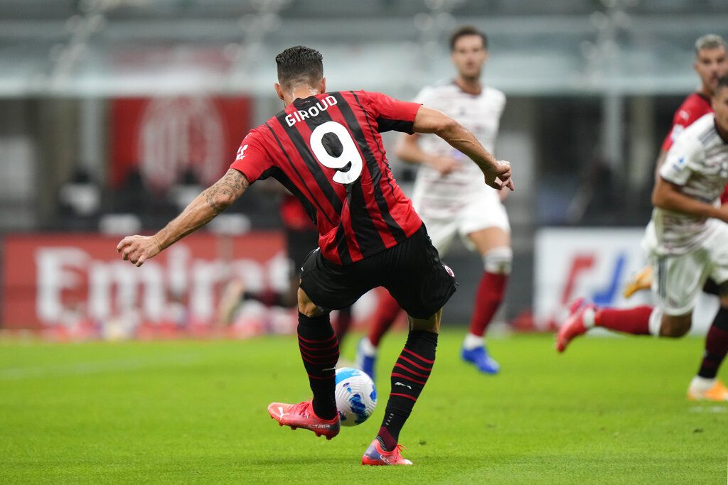 AC Milan's Olivier Giroud celebrates after scoring his side's third goal during a Serie A soccer match between AC Milan and Cagliari, at the San Siro stadium in Milan, Italy, Monday, Aug. 30, 2021. (AP Photo/Luca Bruno)