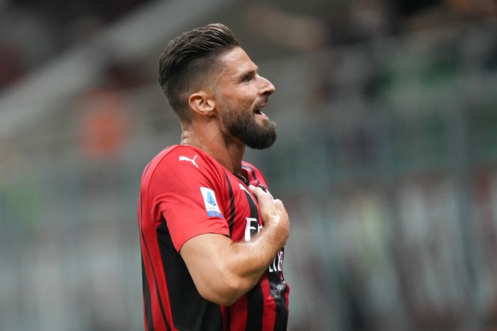 AC Milans Olivier Giroud celebrates after scoring his sides third goal during a Serie A soccer match between AC Milan and Cagliari, at the San Siro stadium in Milan, Italy, Monday, Aug. 30, 2021. (AP Photo/Luca Bruno)