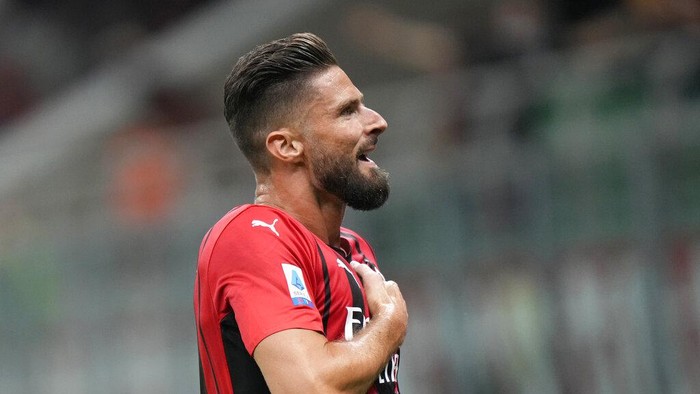 AC Milans Olivier Giroud celebrates after scoring his sides third goal during a Serie A soccer match between AC Milan and Cagliari, at the San Siro stadium in Milan, Italy, Monday, Aug. 30, 2021. (AP Photo/Luca Bruno)