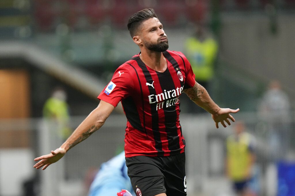 AC Milan's Olivier Giroud celebrates after scoring his side's third goal during a Serie A soccer match between AC Milan and Cagliari, at the San Siro stadium in Milan, Italy, Monday, Aug. 30, 2021. (AP Photo/Luca Bruno)