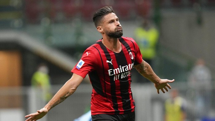 AC Milans Olivier Giroud celebrates after scoring his sides third goal during a Serie A soccer match between AC Milan and Cagliari, at the San Siro stadium in Milan, Italy, Monday, Aug. 30, 2021. (AP Photo/Luca Bruno)