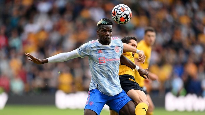 WOLVERHAMPTON, ENGLAND - AUGUST 29: Paul Pogba of Manchester United battles for possession with Joao Moutinho of Wolverhampton Wanderers  during the Premier League match between Wolverhampton Wanderers  and  Manchester United at Molineux on August 29, 2021 in Wolverhampton, England. (Photo by Michael Regan/Getty Images)