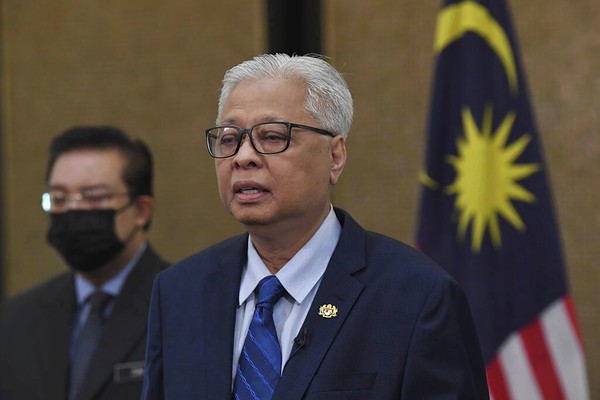 In this photo provided by Prime Minister Office, Malaysias new Prime Minister Ismail Sabri Yaakob speaks at his office in Putrajaya, Malaysia, Friday, Aug. 27, 2021. Ismail retained mostly familiar faces in his Cabinet unveiled Friday, but vowed his government will be more open as it seeks to curb a worsening pandemic. (Prime Minister Office via AP)